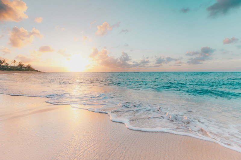 White-sand beach and turquoise sea at golden hour