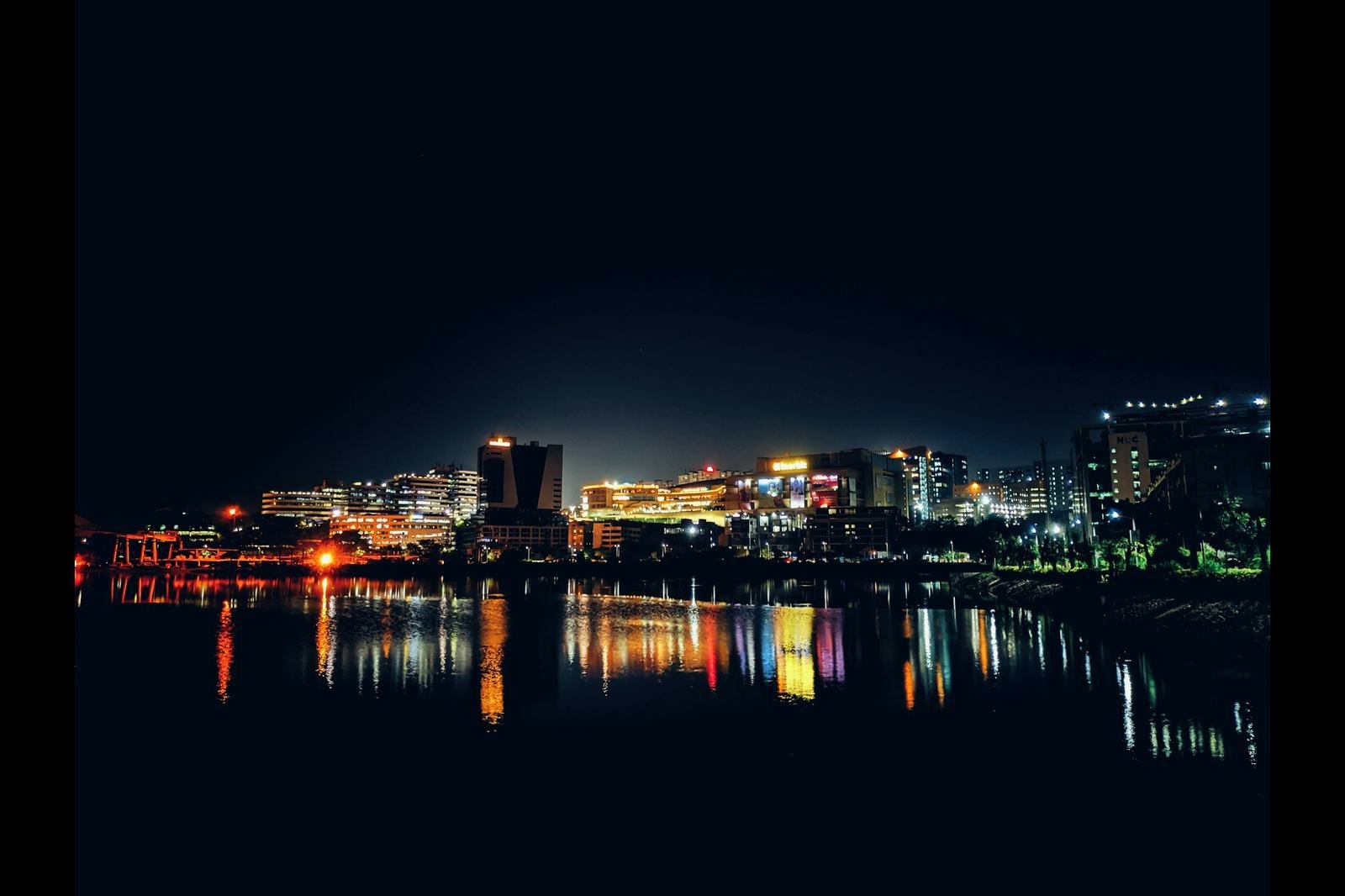 Hyderabad skyline reflected in Durgam Cheruvu lake at night, near Gachibowli