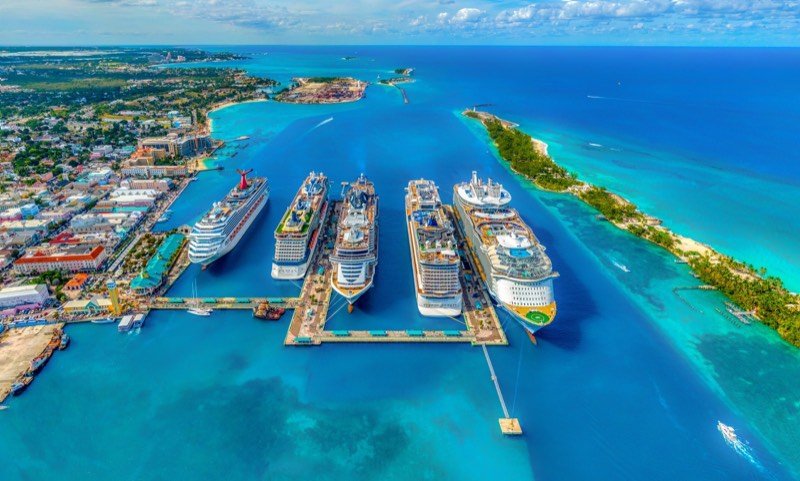 Cruise ships docked in a turquoise harbor, from above