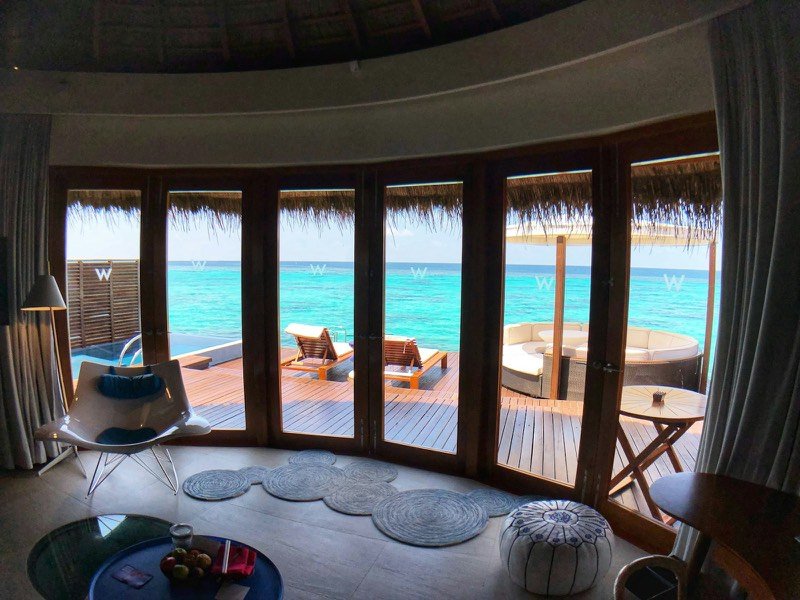 Overwater villa interior opening onto a turquoise lagoon